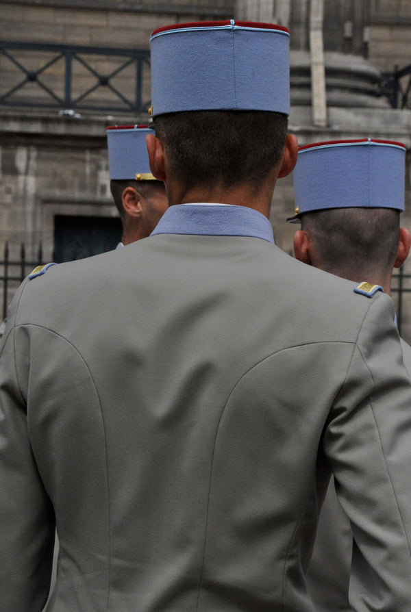 Ross Watson photograph of French soldier in blue cap with grey jacket viewed from behind