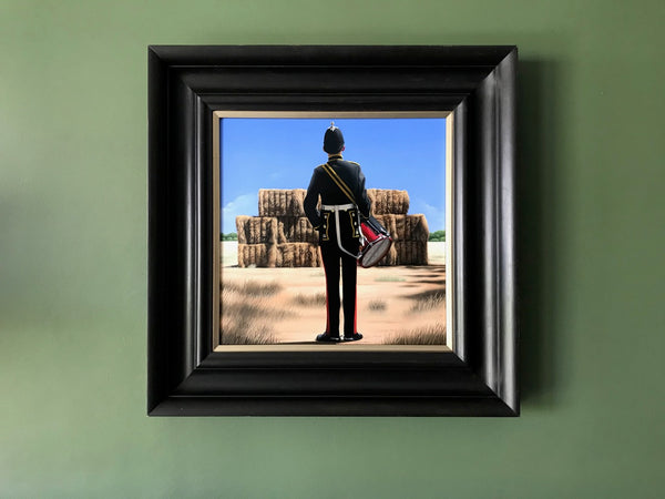 Ross Watson original oil painting of a British military drummer viewed from behind standing in front of a rural Australian haystack framed in an Italianate black frame on a green wall