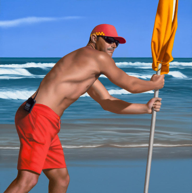 Original Ross Watson oil painting of a shirtless lifeguard wearing red shorts and cap placing a yellow flag into the beach
